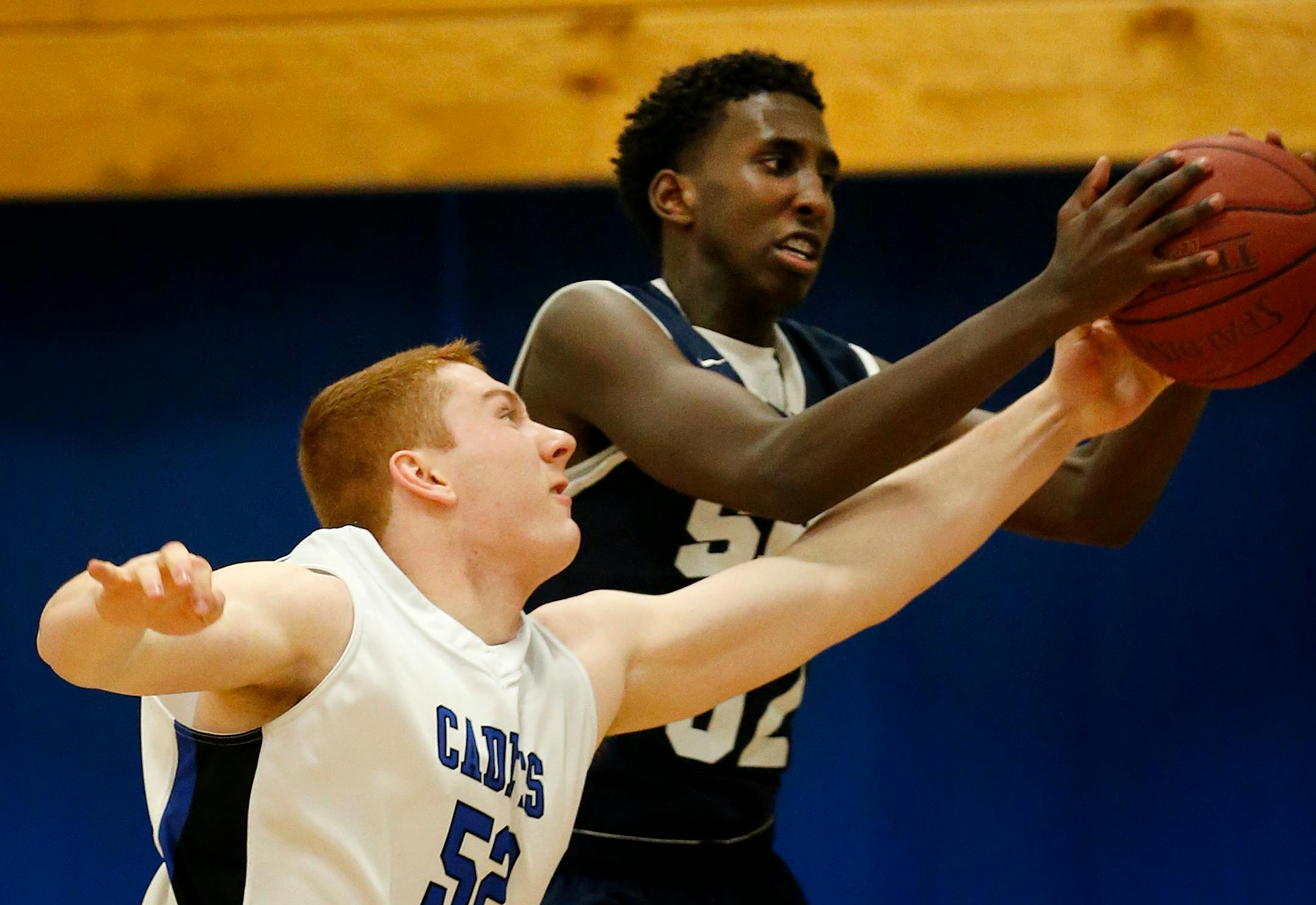 Nate Chaffee (52) of St. Thomas Academy fought for a rebound with Abdulsalan Osman (52) of St. Paul Academy. (Carlos Gonzalez, Star Tribune)