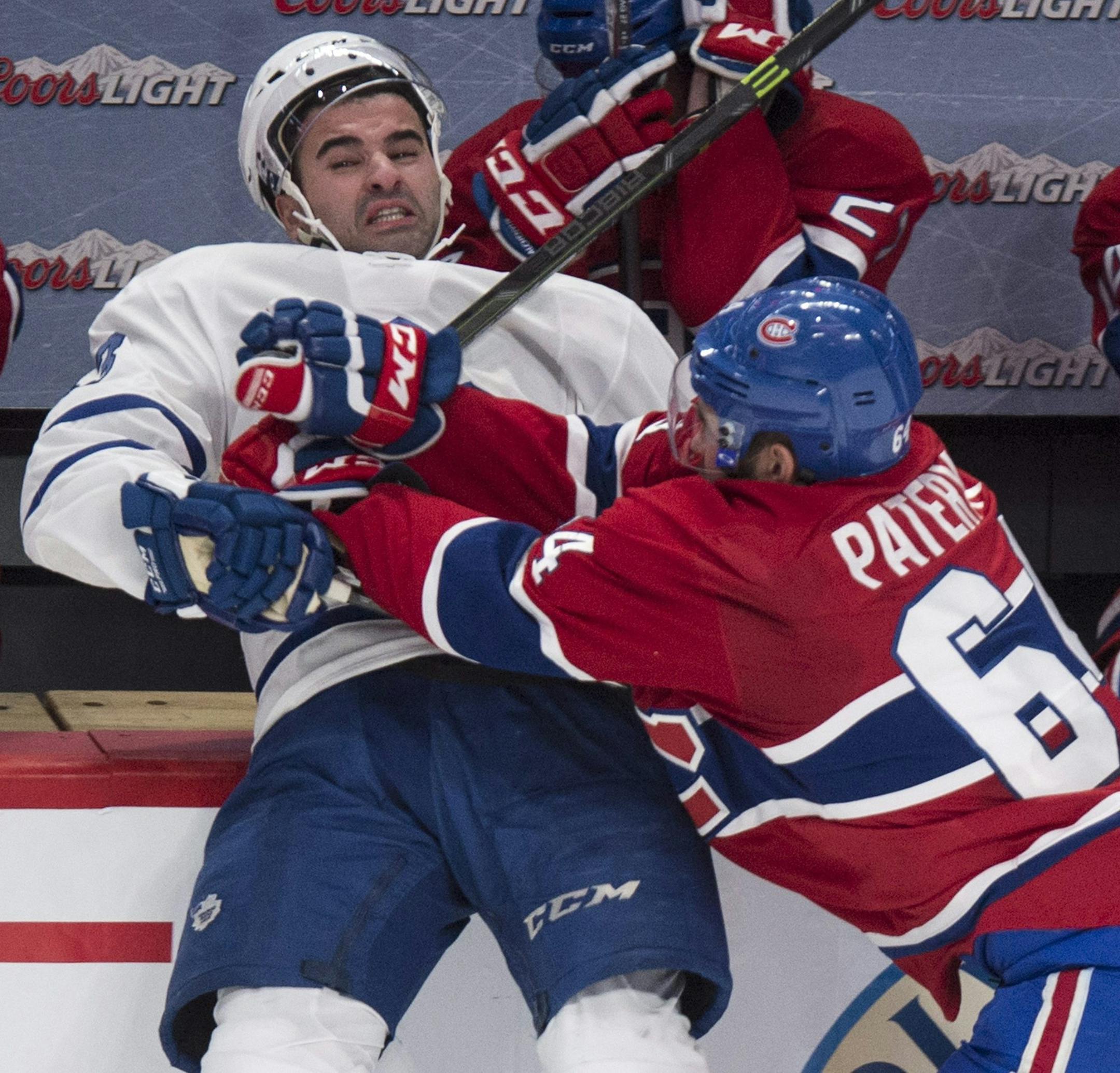 Toronto Maple Leafs' Nazem Kadri, left, is checked into the boards by Montreal Canadiens' Max Pacioretty during third period NHL hockey action Saturday, Feb. 28, 2015 in Montreal. (AP Photo/The Canadian Press, Paul Chiasson) ORG XMIT: MIN2015031323463380