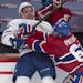 Toronto Maple Leafs' Nazem Kadri, left, is checked into the boards by Montreal Canadiens' Max Pacioretty during third period NHL hockey action Saturda