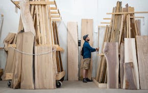 Adam Varney looks at reclaimed wood at Wood from the Hood during the Hennepin County Salvage Crawl's Reuse Ride in Minneapolis on Saturday.
