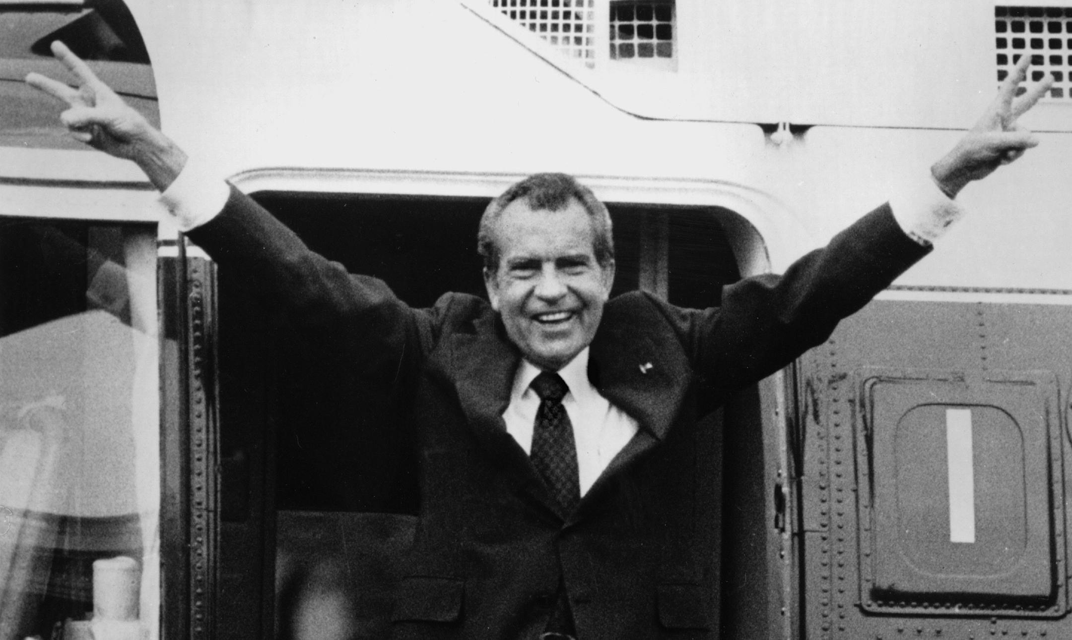 Richard Nixon says goodbye with a victorious salute to his staff members outside the White House as he boards a helicopter after resigning the presidency on Aug. 9, 1974. Nixon was the first president in American history to resign the nation's highest office. His resignation came after approval of an impeachment article against him by the House Judiciary Committee for withholding evidence from Congress. He stepped down as the 37th president with a 2,026-day term, urging Americans to rally behind