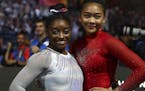 Gold medal winner Simone Biles of the U.S., left, and her team mate Sunisa Lee pose after the women's all-around final at the Gymnastics World Champio