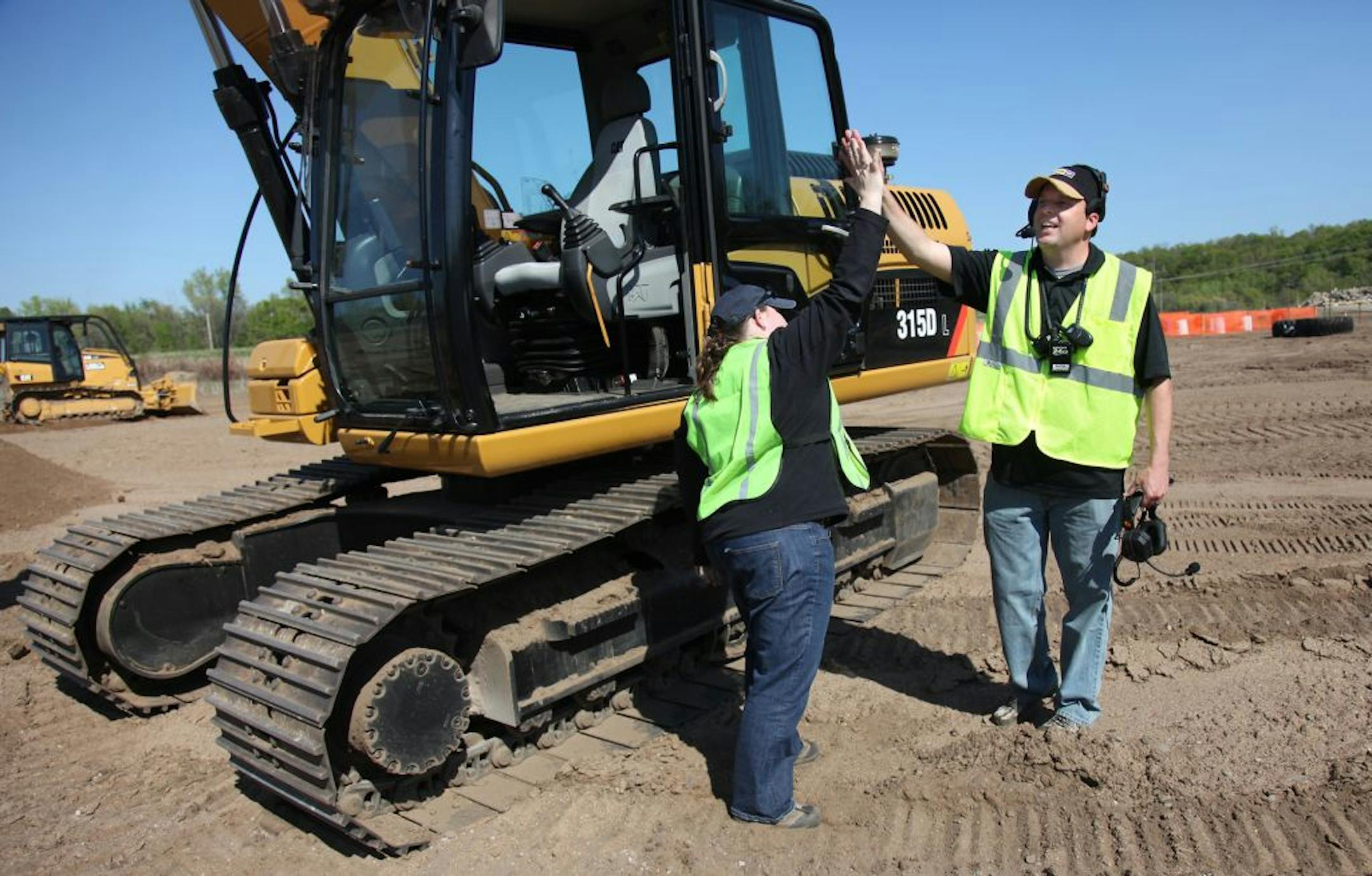Randy Stenger, co-owner of "Extreme Sandbox" gave client Ann Stiff of Woodbury a high-five after she completed the course Tuesday, April 24, 2012 in Hastings MN. (ELIZABETH FLORES/STAR TRIBUNE) ELIZABETH FLORES � eflores@startribune.com