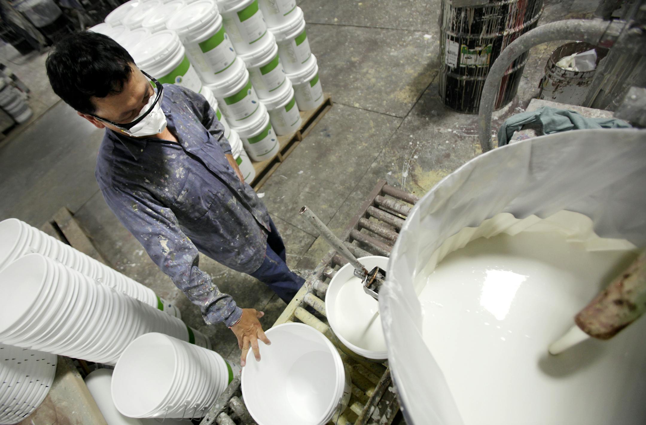 Dang Yang filled buckets of newly mixed paint at Amazon Paint located at 7180 Commerce Circle in Fridley MN. July 16, 2013. ] JOELKOYAMA‚Ä¢joel koyama@startribune