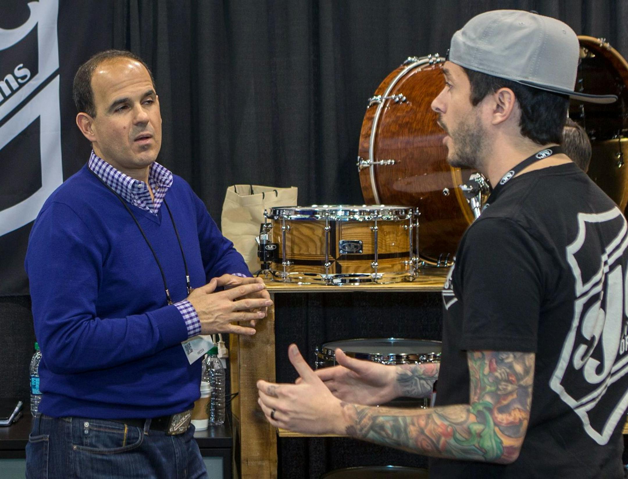 In this Jan. 24, 2015, photo, Marcus Lemonis, of the TV show "The Profit," left, films at the SJC Custom Drums booth during the 2015 National Association of Music Merchants (NAMM) show at the Anaheim Convention Center in Anaheim, Calif. (Photo by Paul A. Hebert/Invision/AP) ORG XMIT: NYBZ132