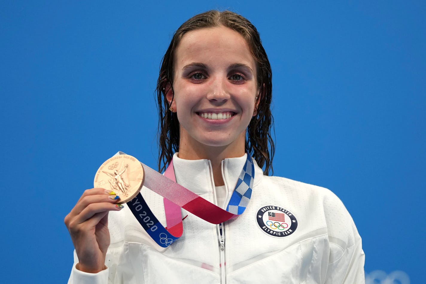 Regan Smith of the United States holds up her bronze medal for the women's 100-meter backstroke at the 2020 Summer Olympics, Tuesday, July 27, 2021, in Tokyo, Japan. (AP Photo/Matthias Schrader)