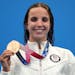 Regan Smith of the United States holds up her bronze medal for the women's 100-meter backstroke at the 2020 Summer Olympics, Tuesday, July 27, 2021, i