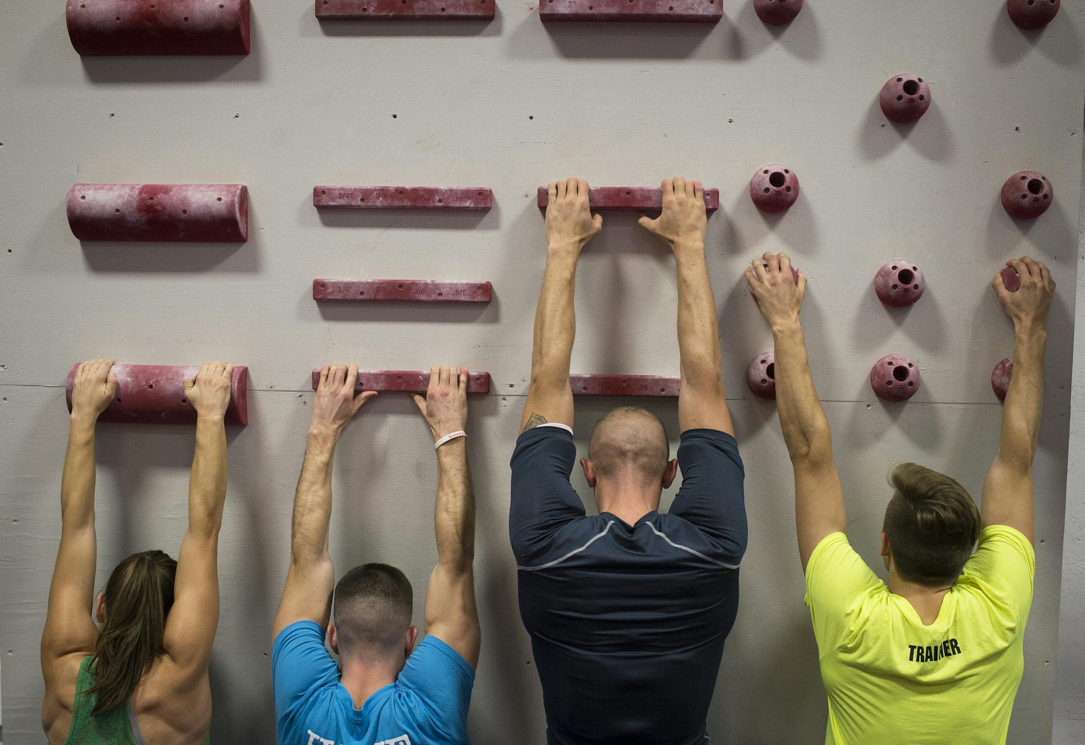 Members of the Ninjas United gym in Buffalo warmed up their hands and fingers on climbing holds at the start of their workout Thursday night. ] (AARON LAVINSKY/STAR TRIBUNE) aaron.lavinsky@startribune.com Profile on Jennifer Tavernier, a local fitness ninja who will appear as a contestant on a new spin-off to the popular American Ninja Warrior TV show. Tavernier trained for the obstacle-course competition at a Minnesota gym called Ninjas United - part of this intense fitness craze. We photograph