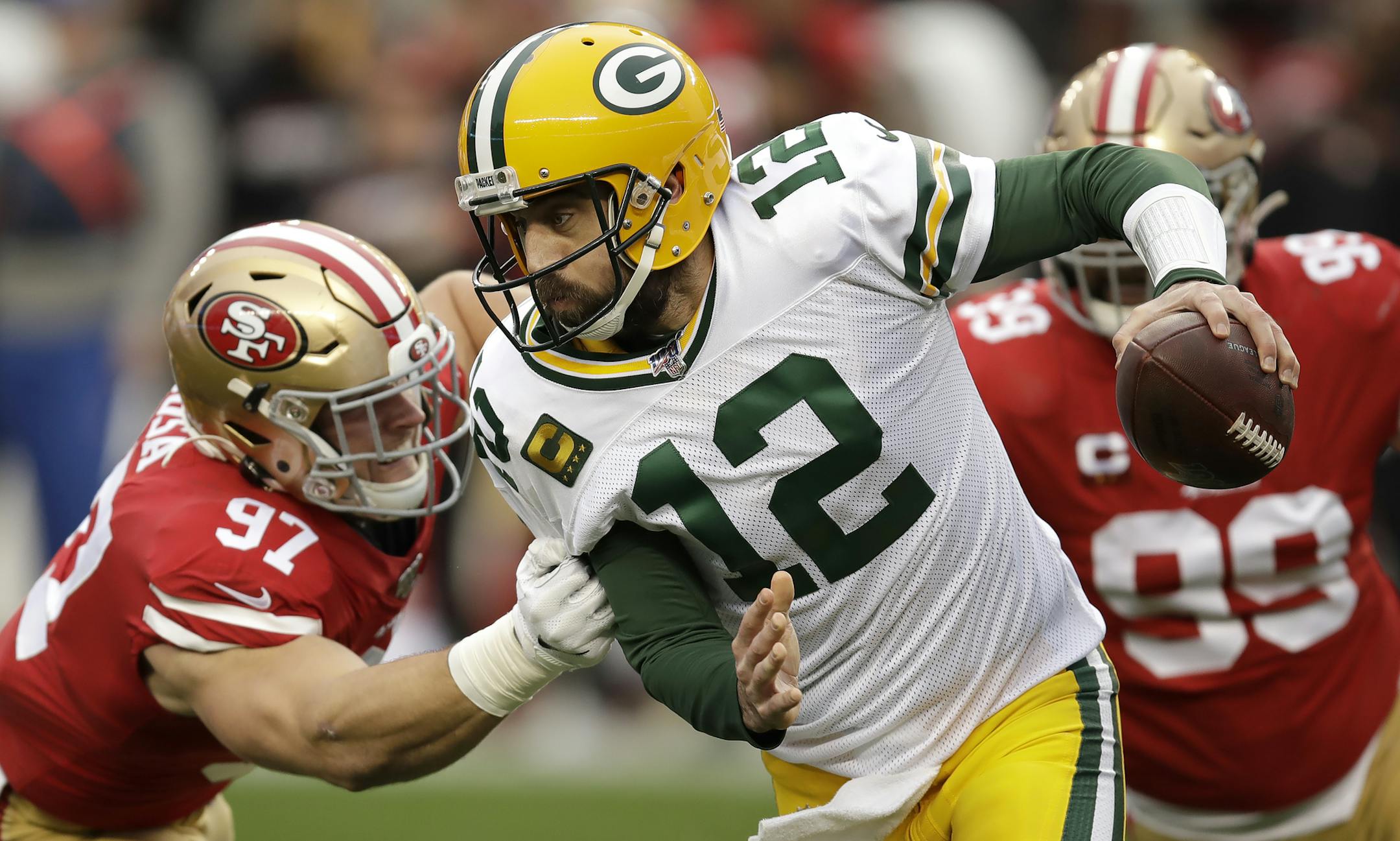 Green Bay Packers quarterback Aaron Rodgers (12) is sacked by San Francisco 49ers defensive end Nick Bosa (97) during the first half of the NFL NFC Championship football game Sunday, Jan. 19, 2020, in Santa Clara, Calif. (AP Photo/Ben Margot)