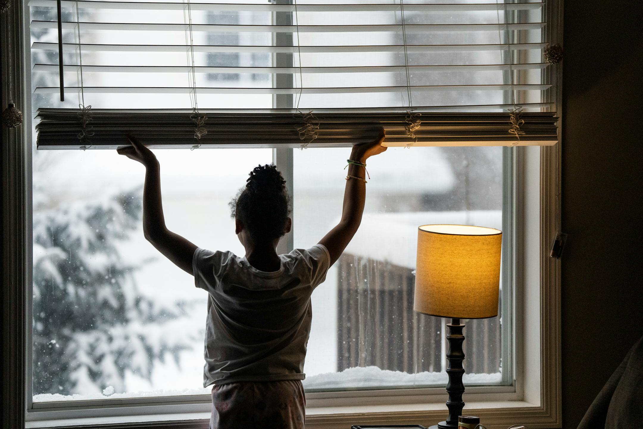 Jalei Haynes, 8, checks out the snow from her home while distance learning during the snow storm in Eagan.