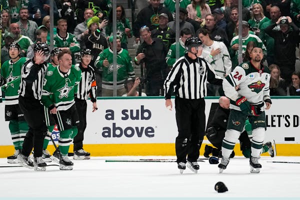The Wild’s Matt Dumba, right, and Dallas’ Max Domi were escorted to the penalty boxes Monday night after Dumba leveled the Stars’ Joe Pavelski w