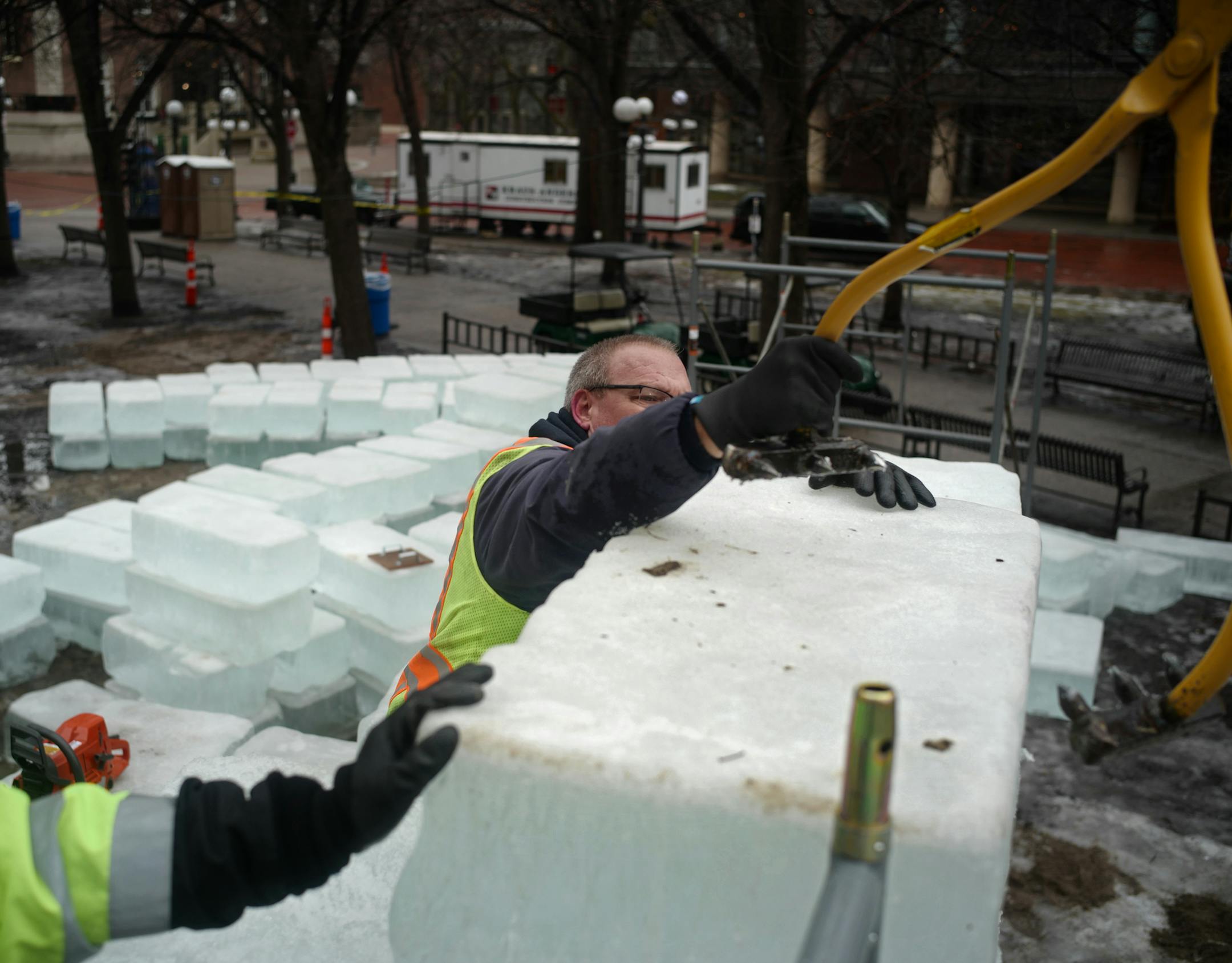 Brian Gullicksen, a mason/cement tradesman helps put one of about 1,600 ice blocks, each weighing some 400 pounds, into place to build a small ice castle in Rice Park. Richard Tsong-Taatarii/rtsong-taatarii@startribune.com