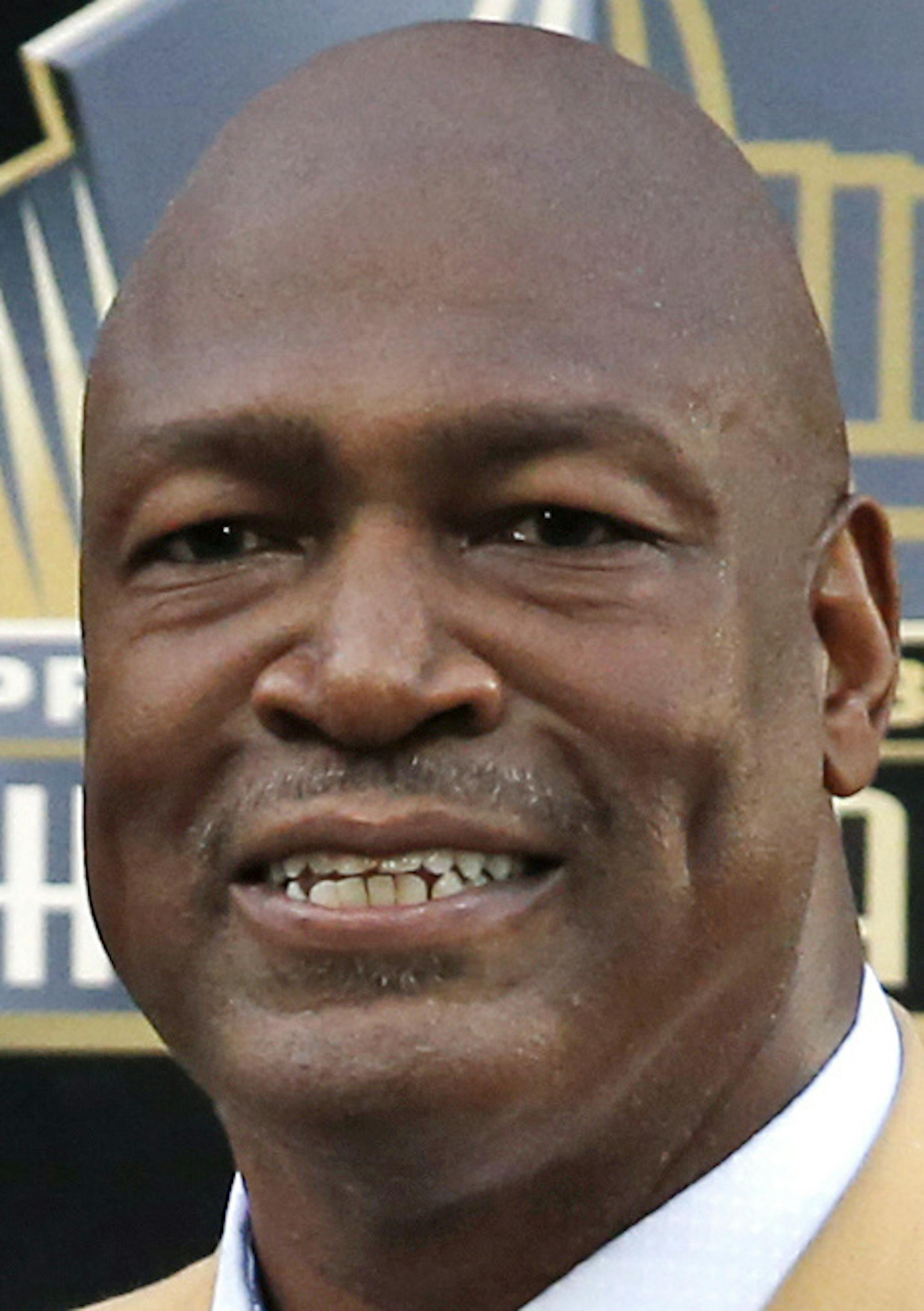Former NFL player Charles Haley poses with his bust during inductions at the Pro Football Hall of Fame, Saturday, Aug. 8, 2015, in Canton, Ohio. (AP Photo/Gene J. Puskar)