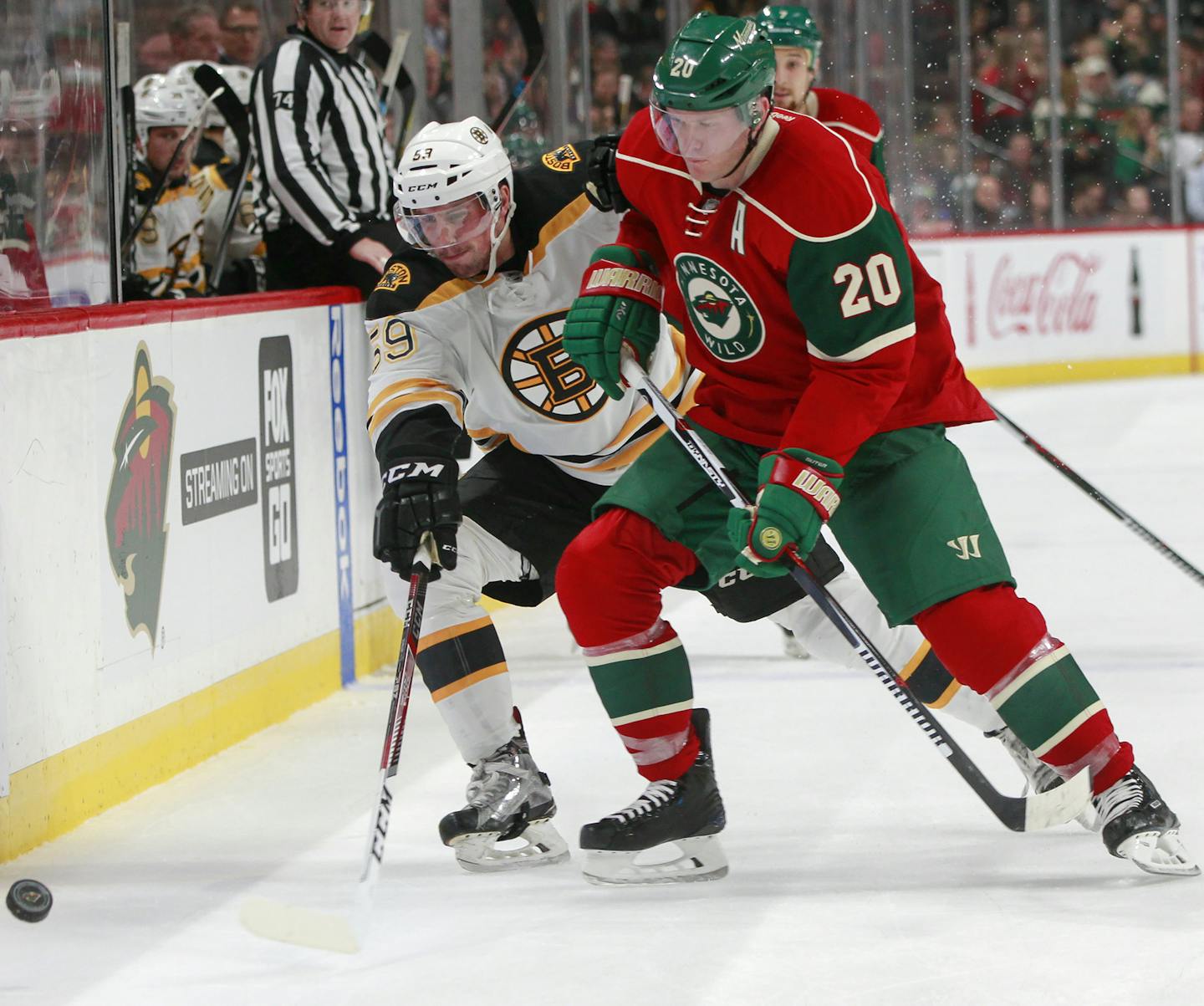 Boston Bruins center Tim Schaller (59) and Minnesota Wild defenseman Ryan Suter (20) battle for the puck during the second period of an NHL hockey game, Thursday, Nov. 17, 2016, in St. Paul, Minn. (AP Photo/Paul Battaglia)