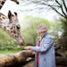 Anne Innis Dagg feeding giraffes in "The Woman Who Loves Giraffes."
Photo by Julie Giles