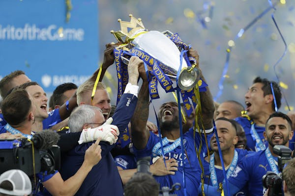 Leicester's Wes Morgan lifted the trophy as Leicester City celebrated becoming the English Premier League soccer champions on May 7, 2016 at King Powe