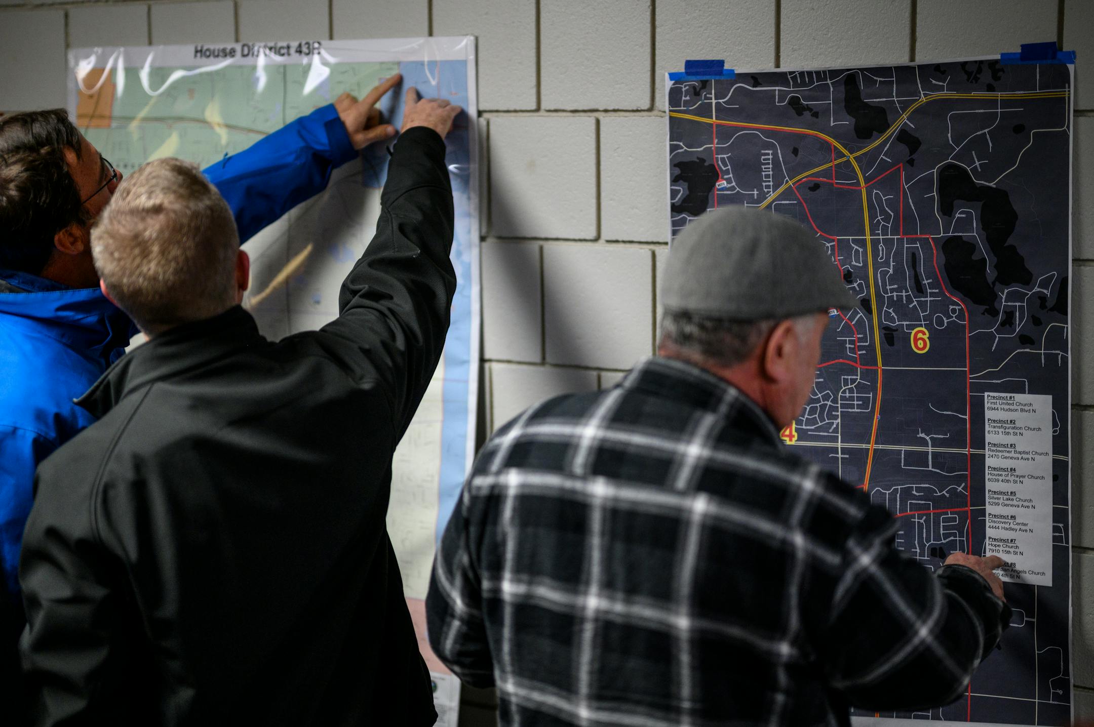 Caucus goers work to confirm their voting precincts before taking part in a GOP Caucus Tuesday, Feb. 1, 2022 at White Bear Lake Area High School in White Bear Lake, Minn.