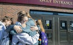 Members of the Rochester Lourdes girls' basketball team hugged after the MSHSL announced the cancellation of the state tournament on March 13. No prep