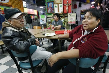 During lunch, Jose Quiroz Cantoran, left, and Candida Mendez, talked and watched CNN in Spanish as they listened to news regarding President Trump's e