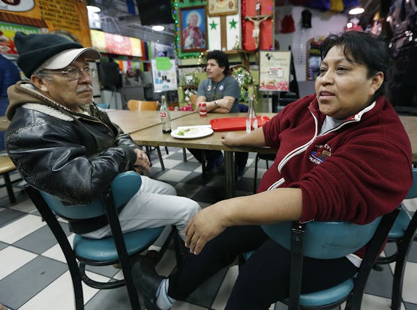 During lunch, Jose Quiroz Cantoran, left, and Candida Mendez, talked and watched CNN in Spanish as they listened to news regarding President Trump's e
