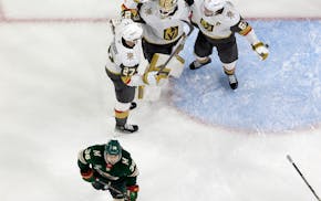 Mats Zuccarello of the Wild skates away Thursday night as Golden Knights players celebrate the end of their 3-2 victory in Game 6 at Xcel Energy Cente