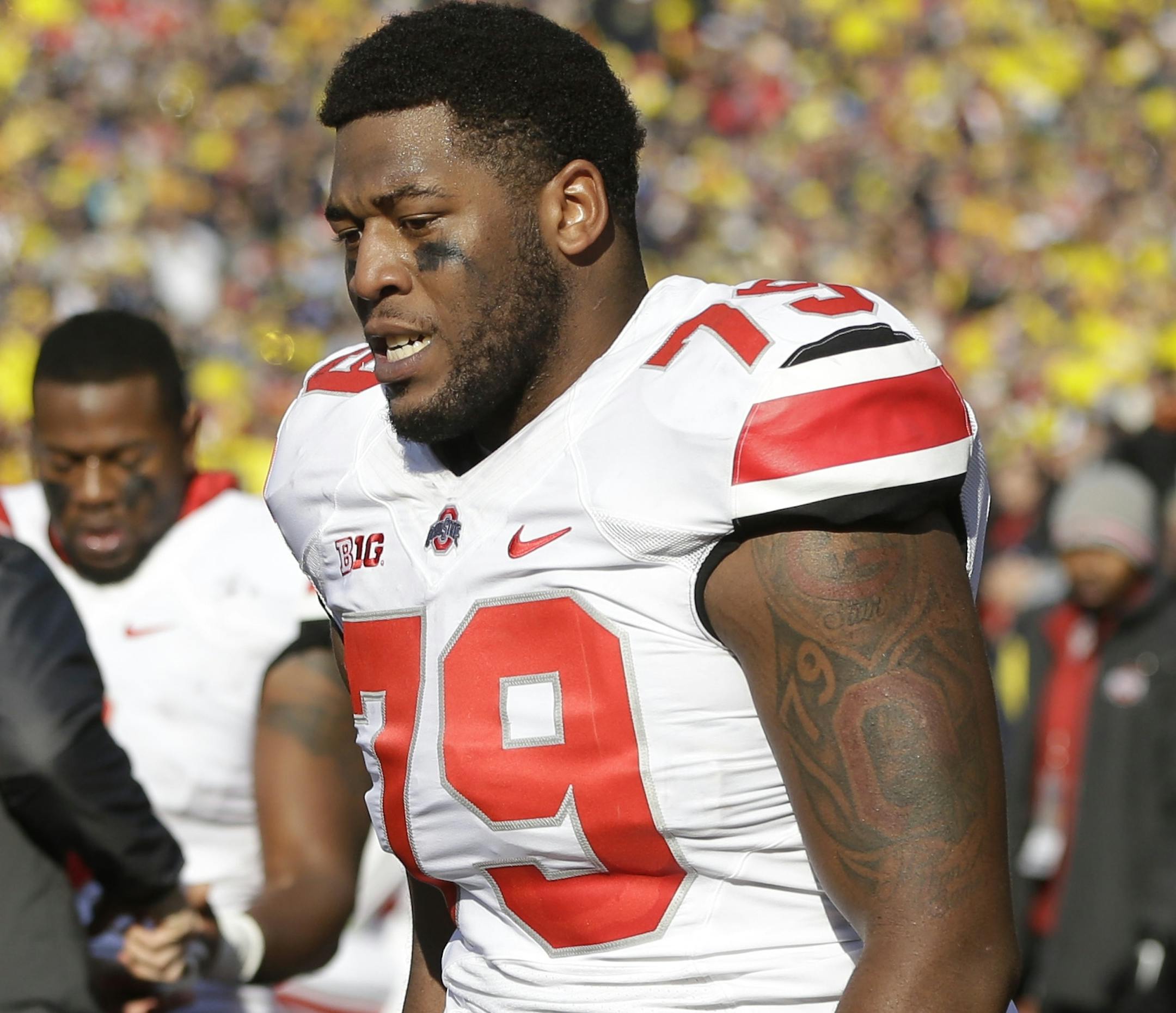 Ohio State offensive linesman Marcus Hall (79) walks the sidelines after being ejected from the game during the second quarter of an NCAA college football game against Michigan in Ann Arbor, Mich., Saturday, Nov. 30, 2013. The third-ranked Buckeyes lost Hall and kick returner Dontre Wilson and the Wolverines lost backup linebacker Royce Jenkins-Stone to ejections. All three players were flagged for unsportsmanlike conduct and had to leave the field after a skirmish. (AP Photo/Carlos Osorio)