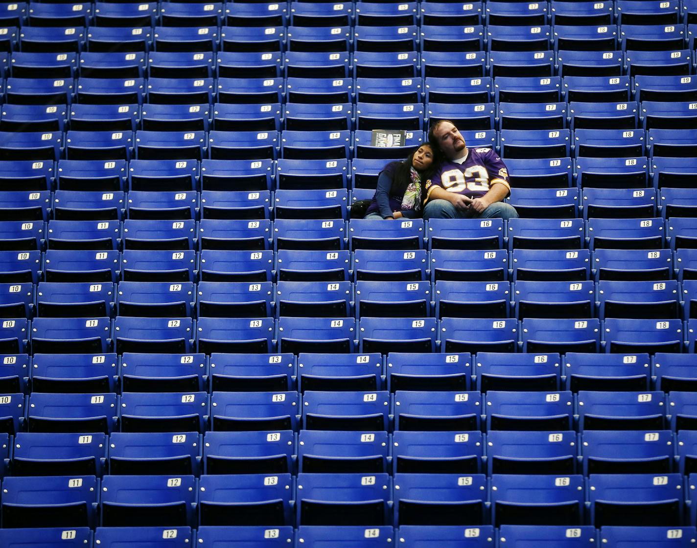 Jason Stockwell and his wife Maria Zaruma, lifelong Viking fans from Columbia Heights, linger in their seats at the Metrodome after the final game in the 32 year old stadium. Stockwell, age 33 remembers coming to the dome as a very young boy. ] Last game at Metrodome - Minnesota Vikings -vs- Detroit Lions Minneapolis, MN 12/29//2013