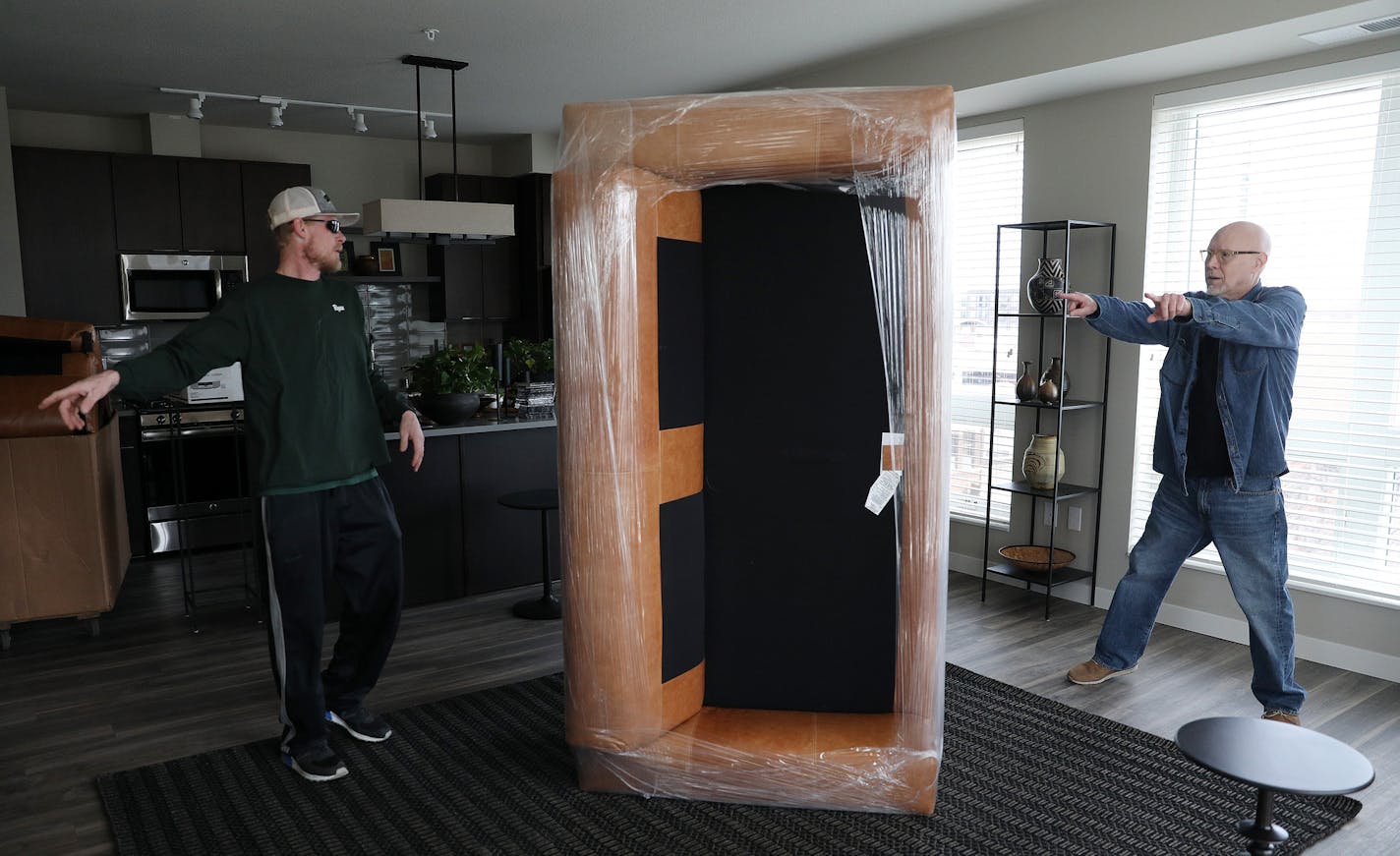 Bruce Tomlinson directed movers from Good Stuff Moving as they brought up his belongings from the truck to his new apartment at the M on Hennepin. ] ANTHONY SOUFFLE &#xef; anthony.souffle@startribune.com Bruce Tomlinson, a retired school social worker, moved from St. Paul to the M on Hennepin apartments Thursday, April 26, 2018 in Minneapolis. ORG XMIT: MIN1804300929457503