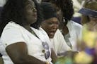 Louise Karluah, center, Barway Collins' biological mother from Liberia, sobs during Barway's funeral on Saturday afternoon.