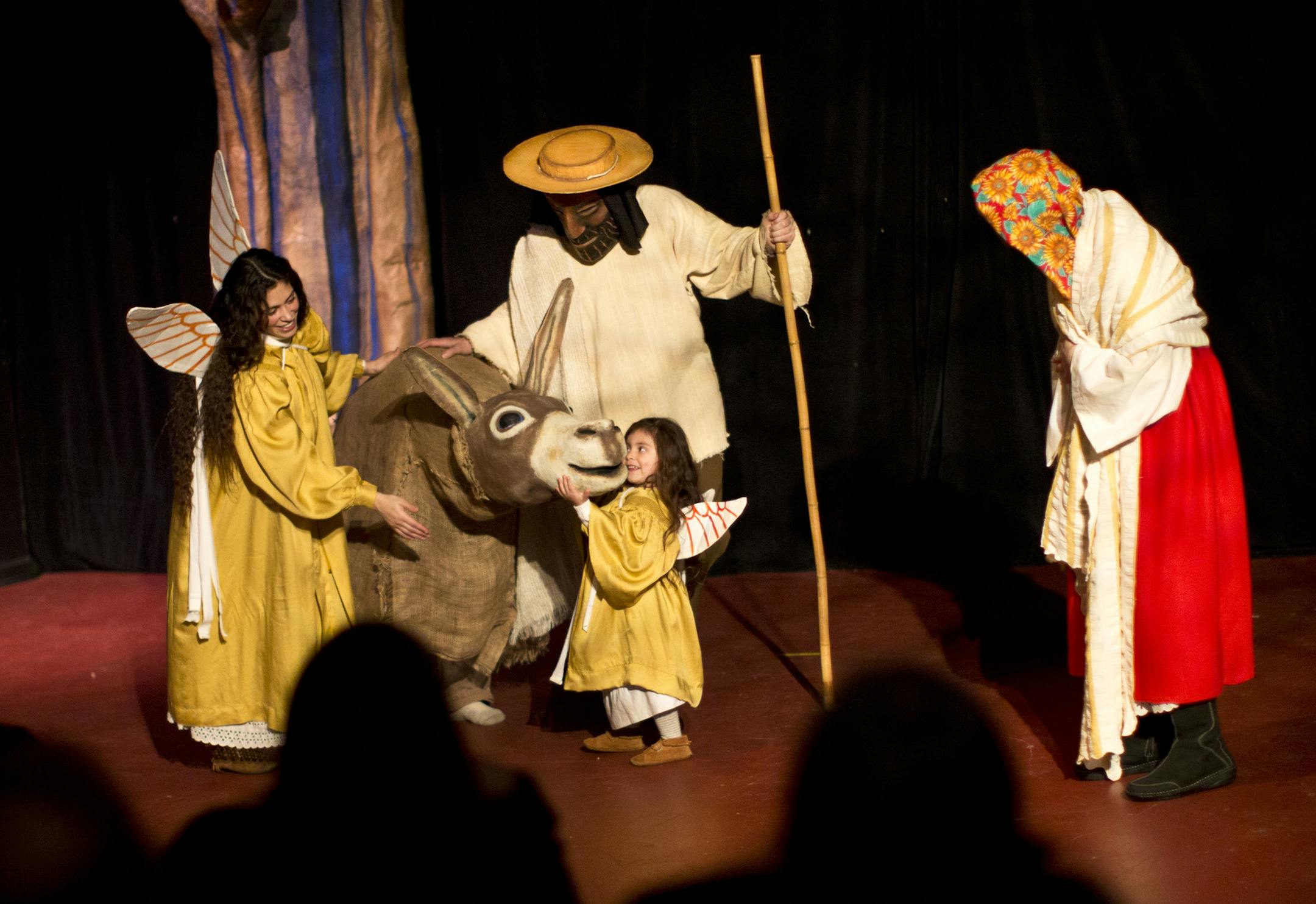 Three-year-old Imix Ybarra, playing an angel, led the donkey across the stage in a scene where Mary and Joseph travel to Bethlehem to find shelter in the Heart of the Beast Puppet and Mask Theatre's La Natividad on December 13, 2012 in Minneapolis, Minn. ] (RENEE JONES SCHNEIDER • reneejones@startribune.com)