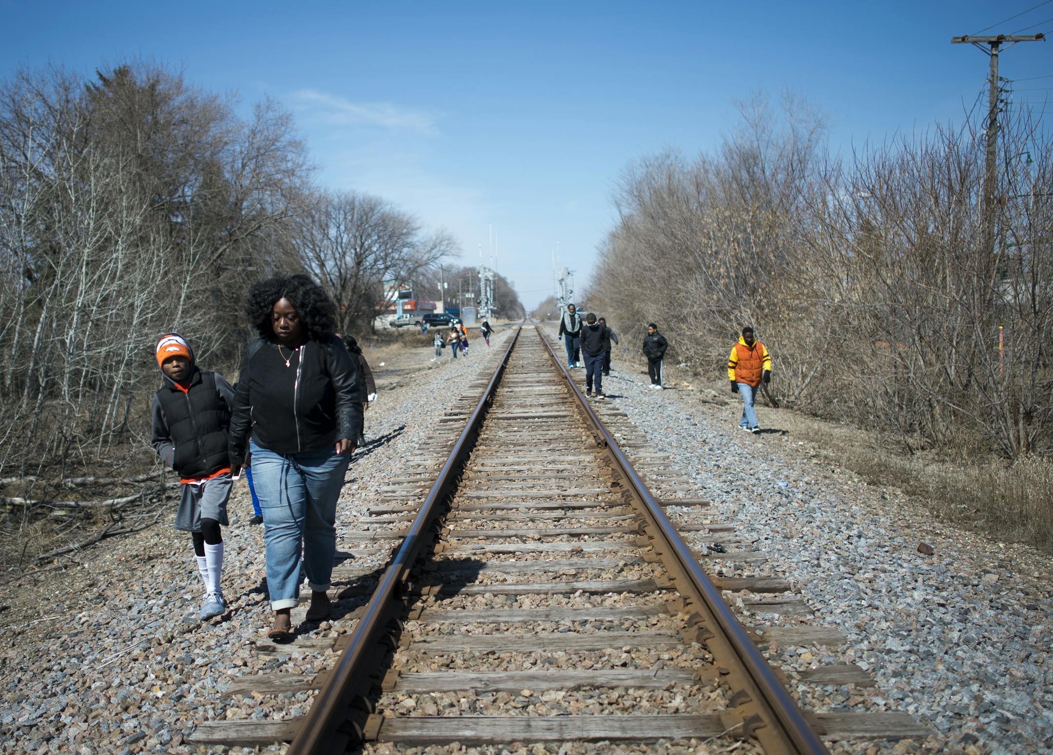 Members of the community search along the railroad tracks in Crystal for signs of missing 10-year old Barway Collins after a prayer service on Saturday. ] (Aaron Lavinsky | StarTribune) A press conference and prayer service marking day 10 of the disappearance of 10-year old Barway Collins were held on Saturday, March 28, 2015 in Crystal, MN.