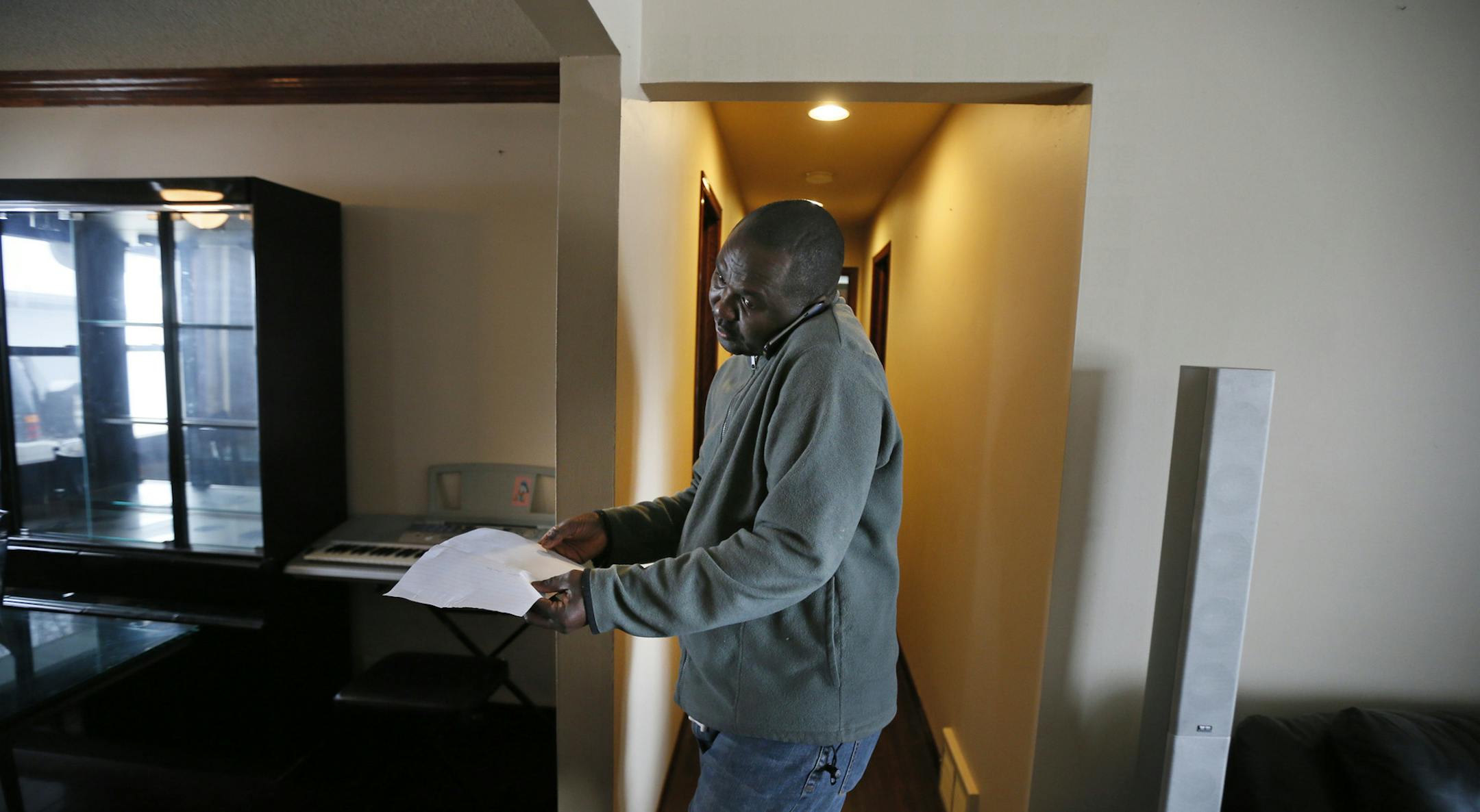 Robertson Karmo looked over some paperwork at their new home Wednesday April, 10 2013 in Brooklyn Center, MN. ] JERRY HOLT ‚Ä¢ jerry.holt@startribune.com