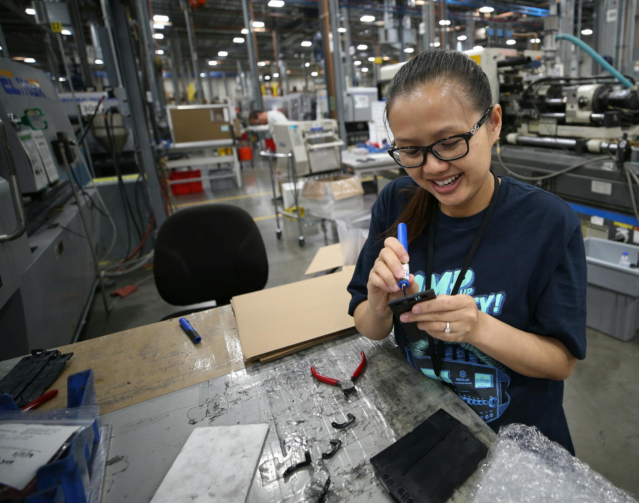 Protolabs employee Truly Paw worked at a station inside the Rosemount location nearly two months after her daughter was born on Valentine's Day, 2019. ] Shari L. Gross &#xa5; shari.gross@startribune.com Protolabs injection molding trainer Truly Paw will be teaching other workers how to work the large molding machines. **ED NOTE** Truly wasn't conducting any training while I was there. She was trimming away excess plastic from edges of pieces that had been pressed.
