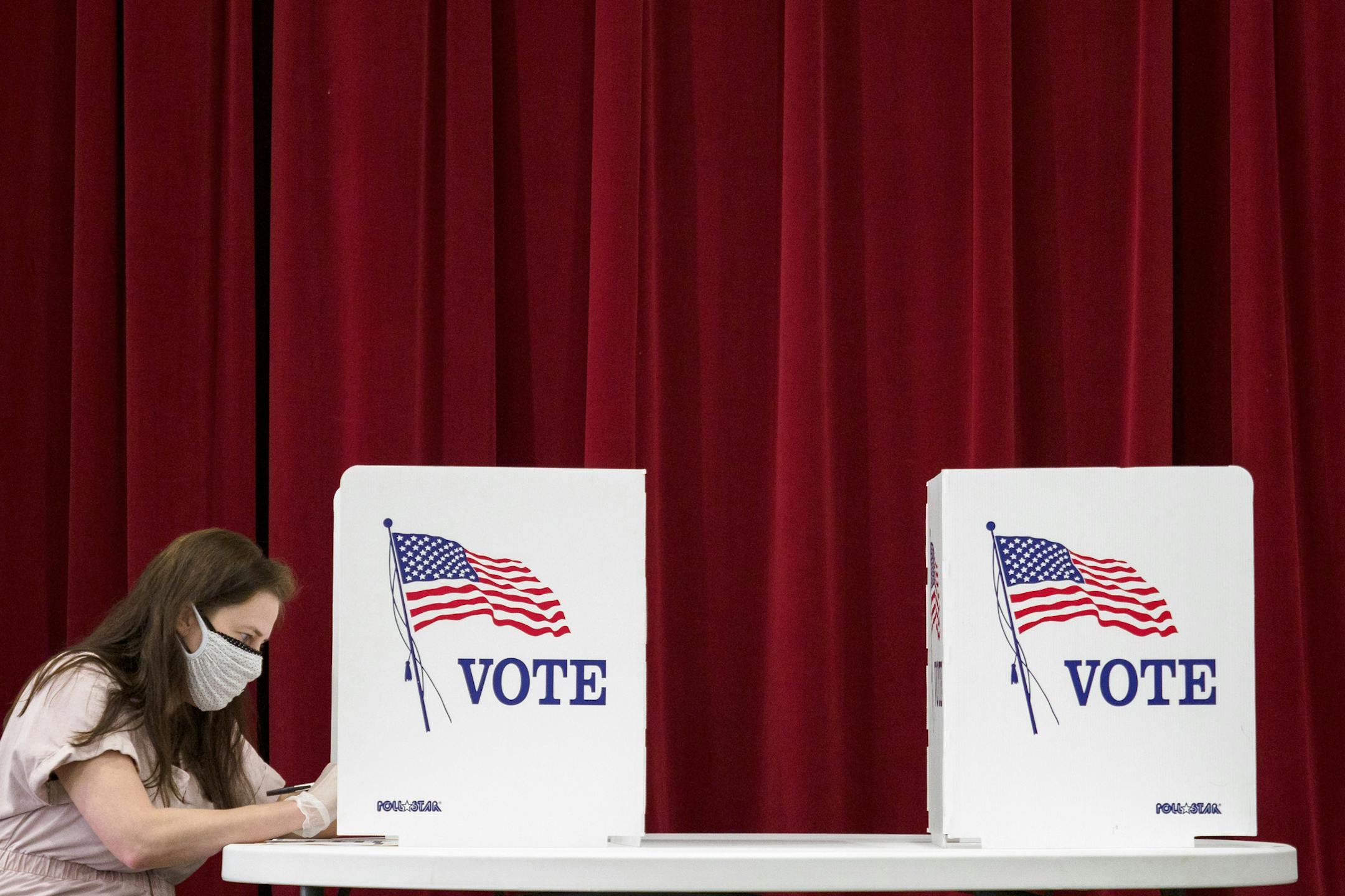 Elizabeth Snow fills out her ballot at Red Bank Cumberland Presbyterian Church on Thursday, Aug. 6, 2020, in Red Bank, Tenn. Election Day in pandemic times has arrived in Tennessee, where voters Thursday will decide a heated Republican U.S. Senate primary and other federal and state contests. (C.B. Schmelter/Chattanooga Times Free Press via AP)