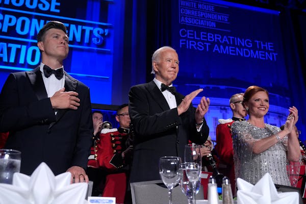 Host Colin Jost, from left, President Joe Biden and Kelly O'Donnell, WHCA vice president and Senior White House correspondent for NBC News, stand duri