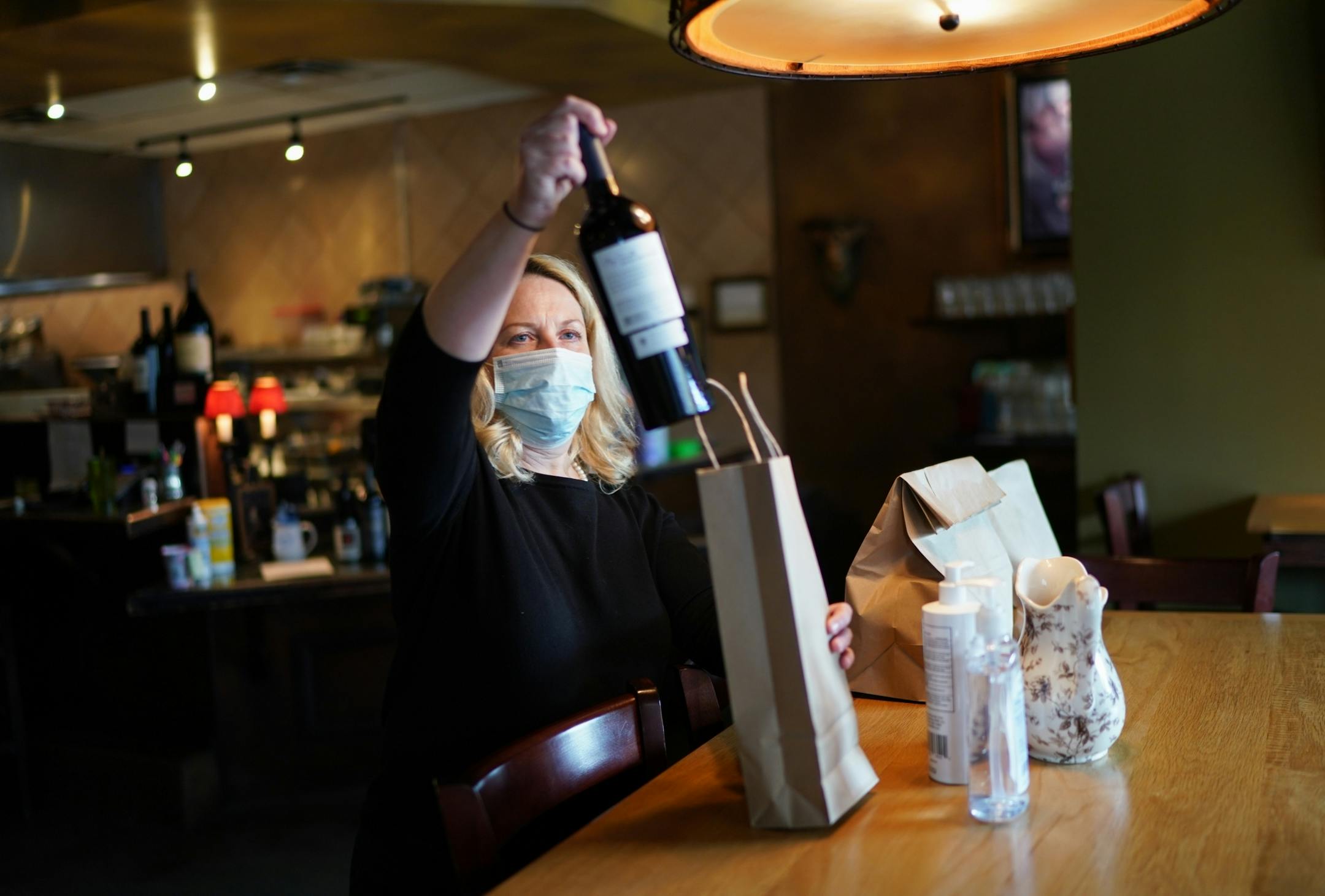 Jennifer King, owner of Prima, kept an eye on the food delivery parking spots in front of her restaurant on Lyndale Ave and she delivered their orders. In between deliveries, she checked for incoming orders on her phone.
