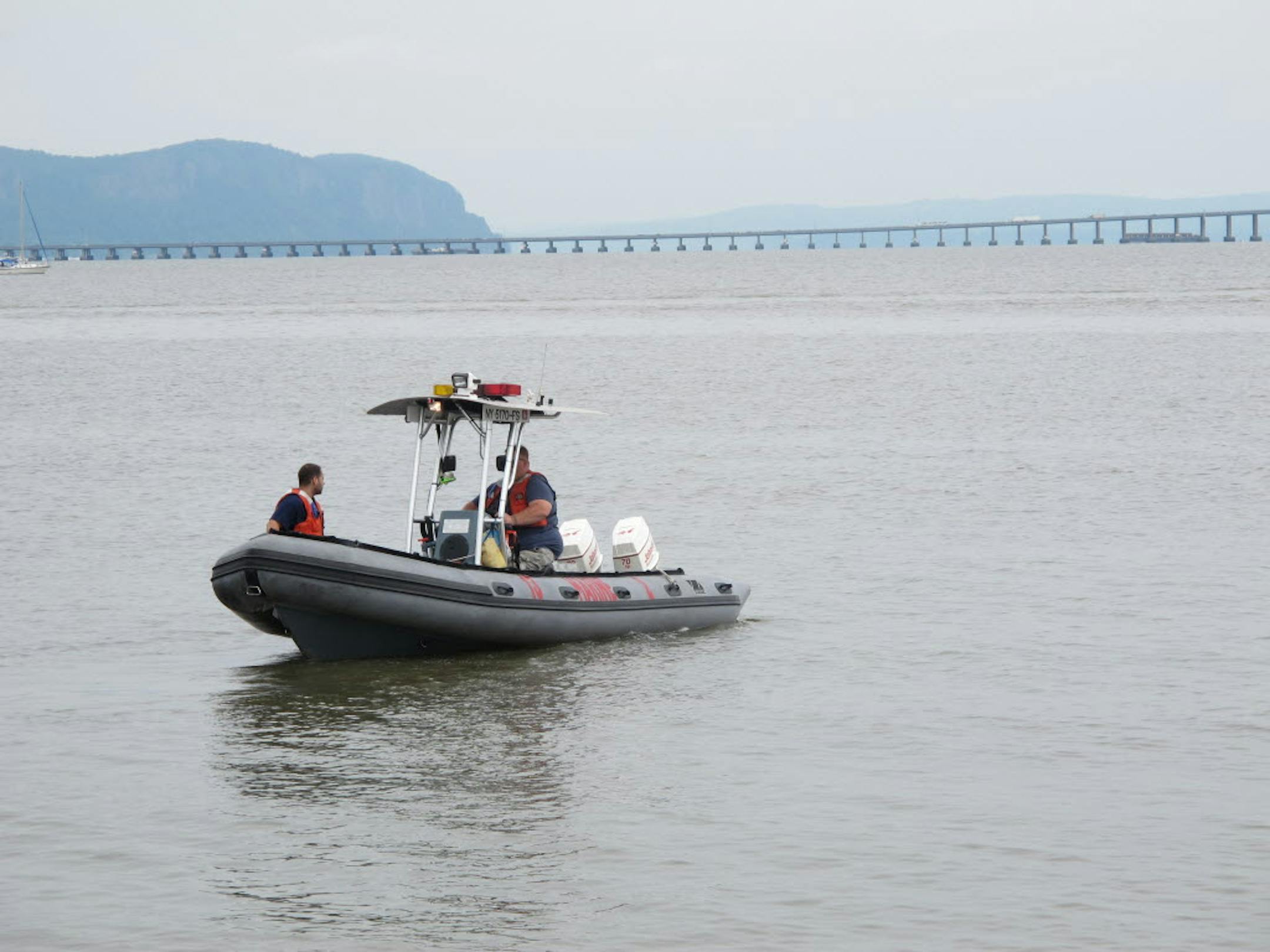 Members of the fire and rescue squad in Piermont, N.Y., begin searching on Sunday, July 28, 2013, for Mark Lennon, 30, who was missing after a boating accident in the Hudson River on Friday night. A body believed to be Lennon's was found later Sunday.