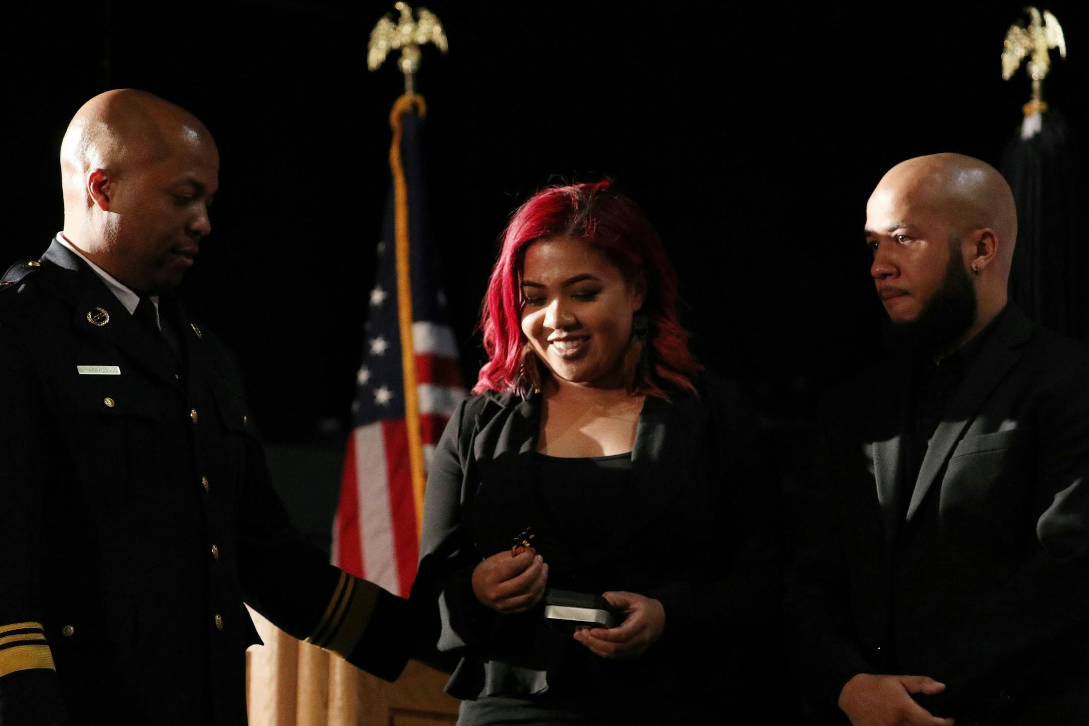 Newly appointed Minneapolis Police Chief Medaria Arradondo's got his badge pinned on hm by his daughter Nyasia as his son Medaria Jr. looked on after their father took the oath of office during a public swearing-in ceremony Friday.