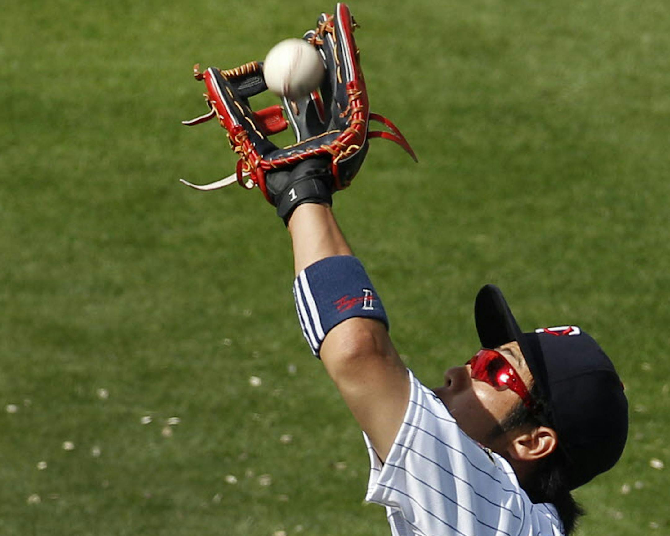 Twins second baseman Tsuyoshi Nishioka fielded a fly ball by the Cardinals' Daniel Descalso during the seventh inning of a spring training game in Fort Myers, Fla., on Friday.