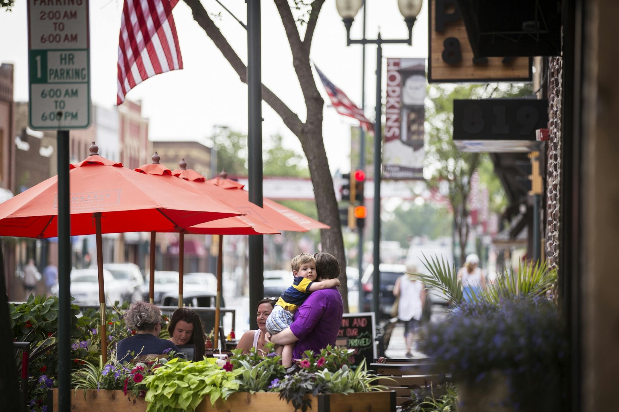 Oliver Wolf, 2, of Rochester holds onto his mother Jess at Pub 819 on Mainstreet in Hopkins on Tuesday, July 14, 2015.