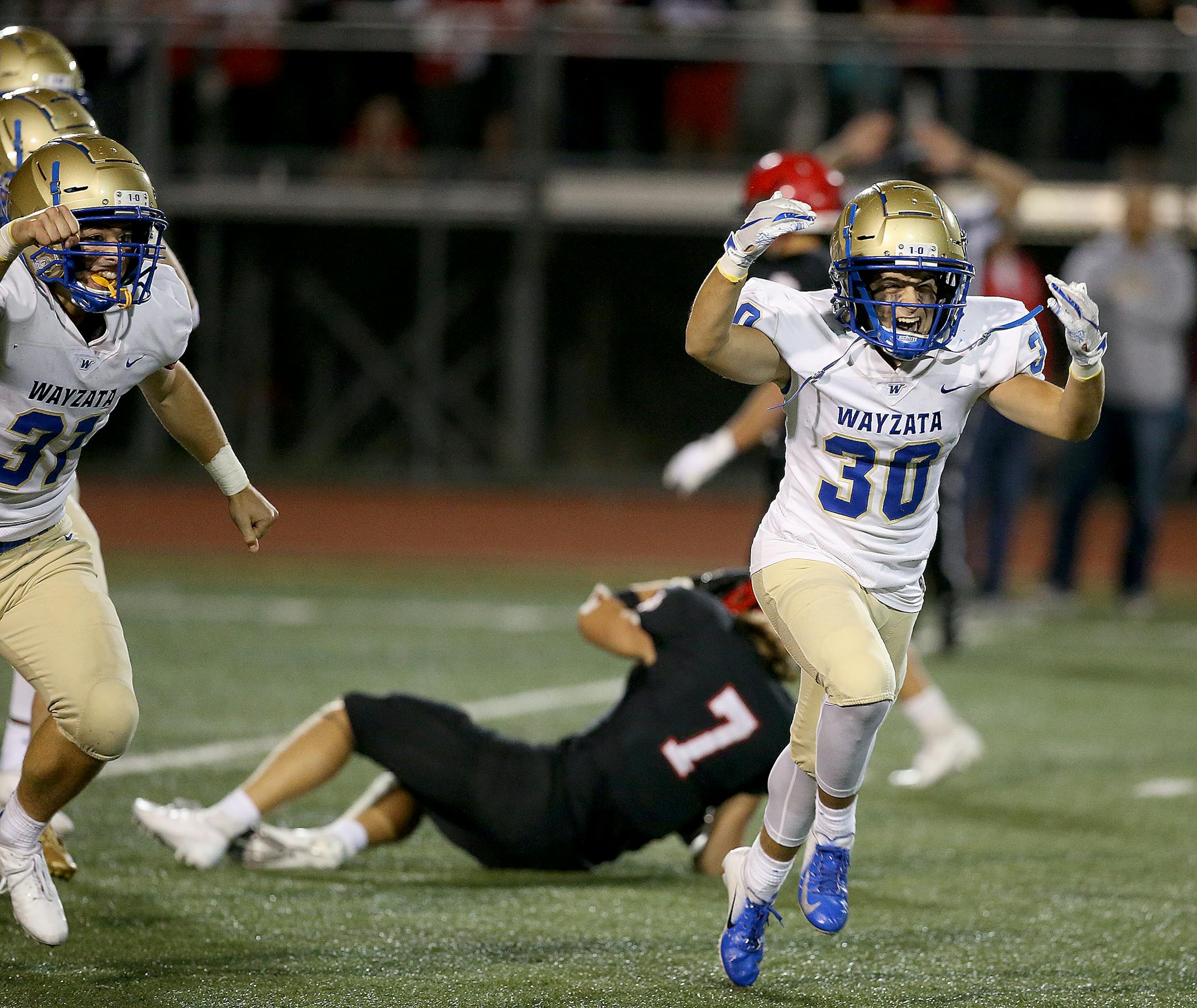 Wayzata defenders Daniel Sandall and Cole Brown celebrate their fumble recovery on a punt against Eden Prairie
