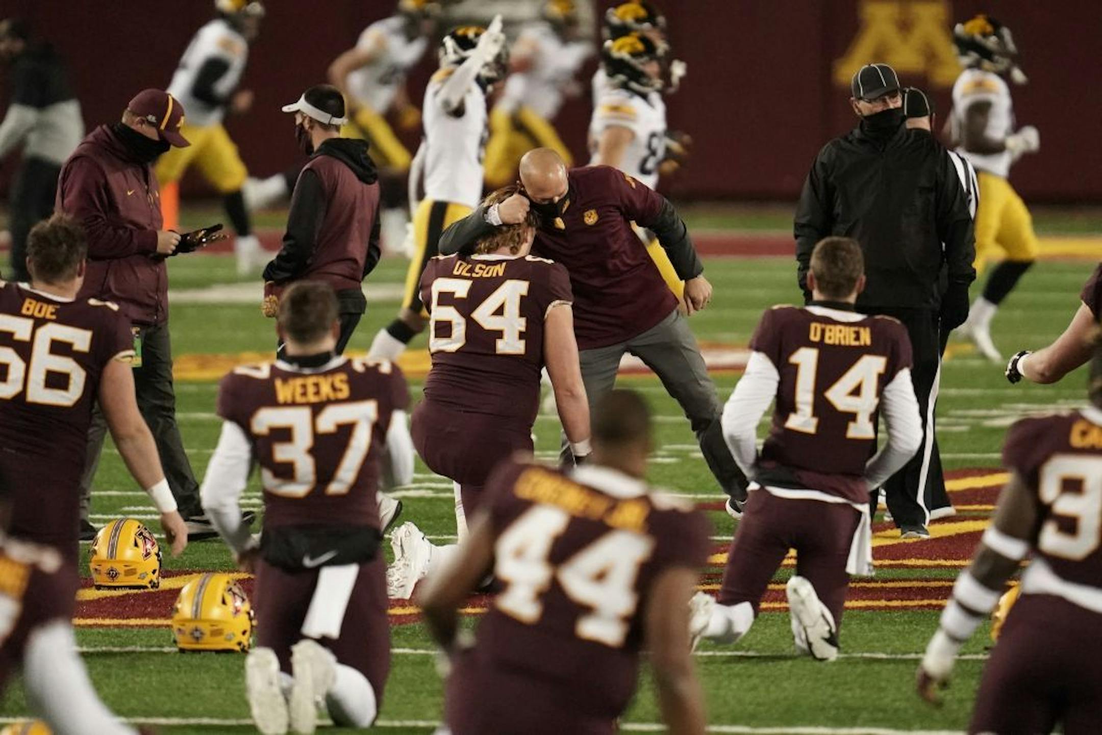 Minnesota Gophers head coach P.J. Fleck embraced Minnesota Gophers offensive lineman Conner Olson (64) before the game,