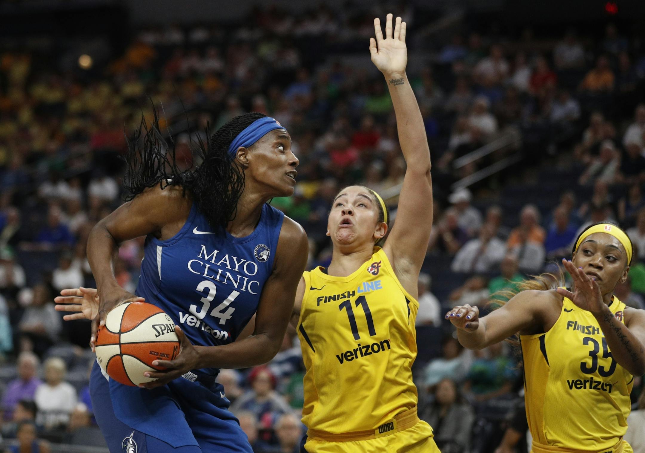 Lynx Sylvia Fowles scored one of her 18 points in the first half over Fever Natalie Achonwa at Target Center Wednesday July 18, 2018 in Minneapolis , MN.