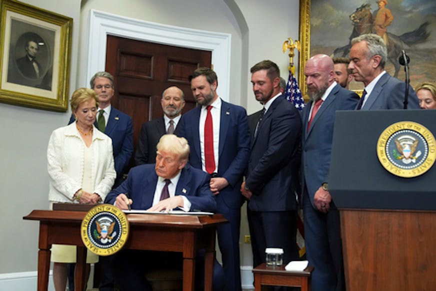 President Donald Trump signs an executive order July 31, 2025, restarting the Presidential Fitness Test in public schools. (AP Photo/Jacquelyn Martin)