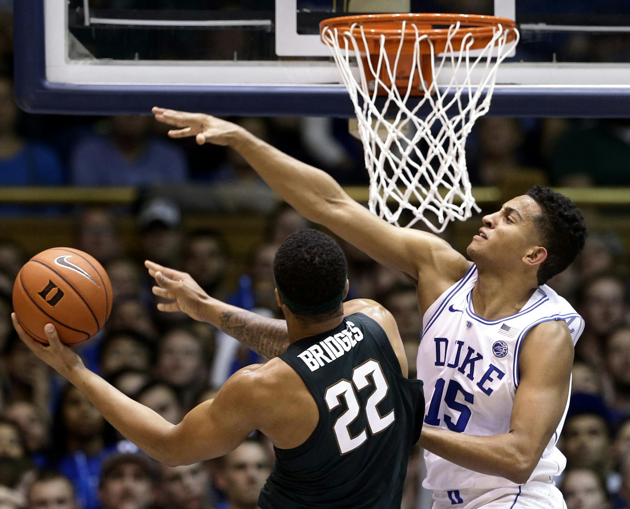Duke's Frank Jackson (15) defends against Michigan State's Miles Bridges (22) during the first half of an NCAA college basketball game in Durham, N.C., Tuesday, Nov. 29, 2016. (AP Photo/Gerry Broome)