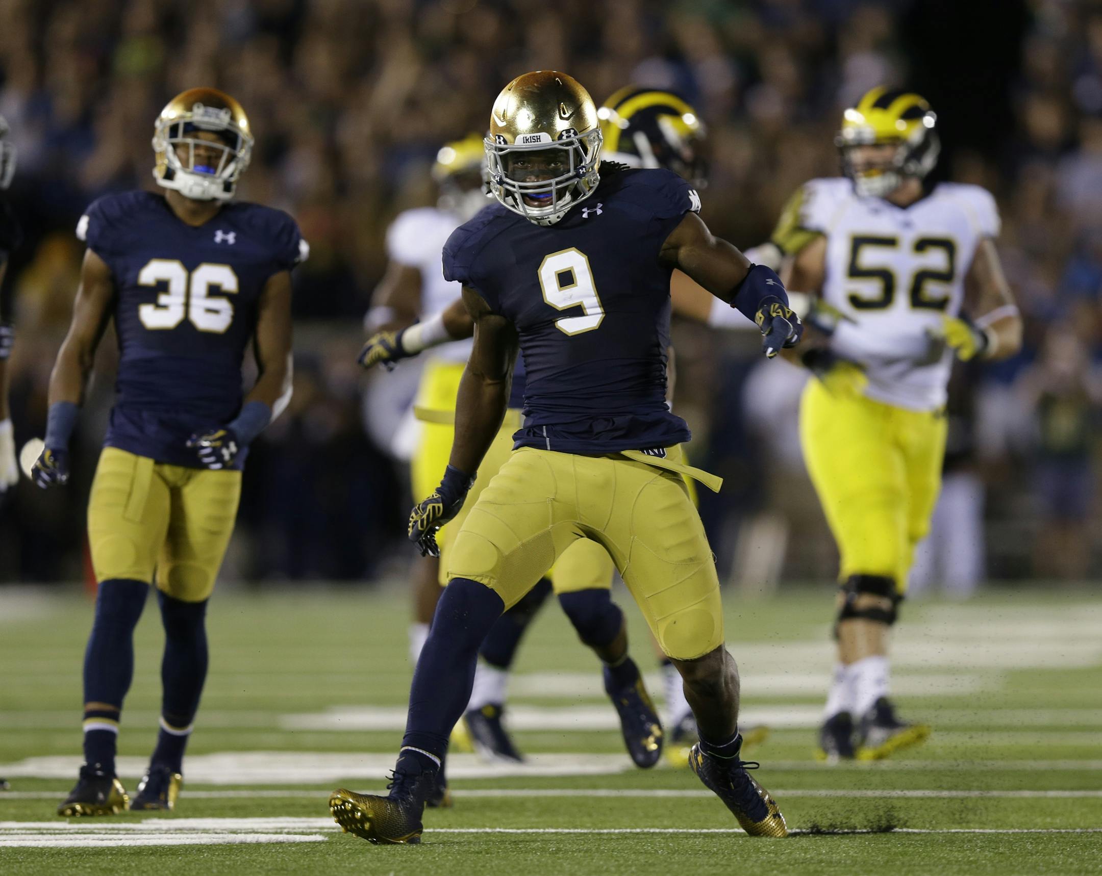 Notre Dame linebacker Jaylon Smith celebrates a tackle for a loss against Michigan during the second half of an NCAA college football game in South Bend, Ind., Saturday, Sept. 6, 2014. (AP Photo/Michael Conroy) ORG XMIT: INMC121