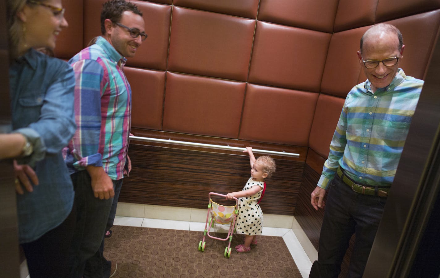 Top photo, Betsy Kuller and husband Ben Gerber boarded an elevator with daughter Rozlyn, 2, and Kuller&#x2019;s father, Hart, at the Carlyle in downtown Minneapolis.