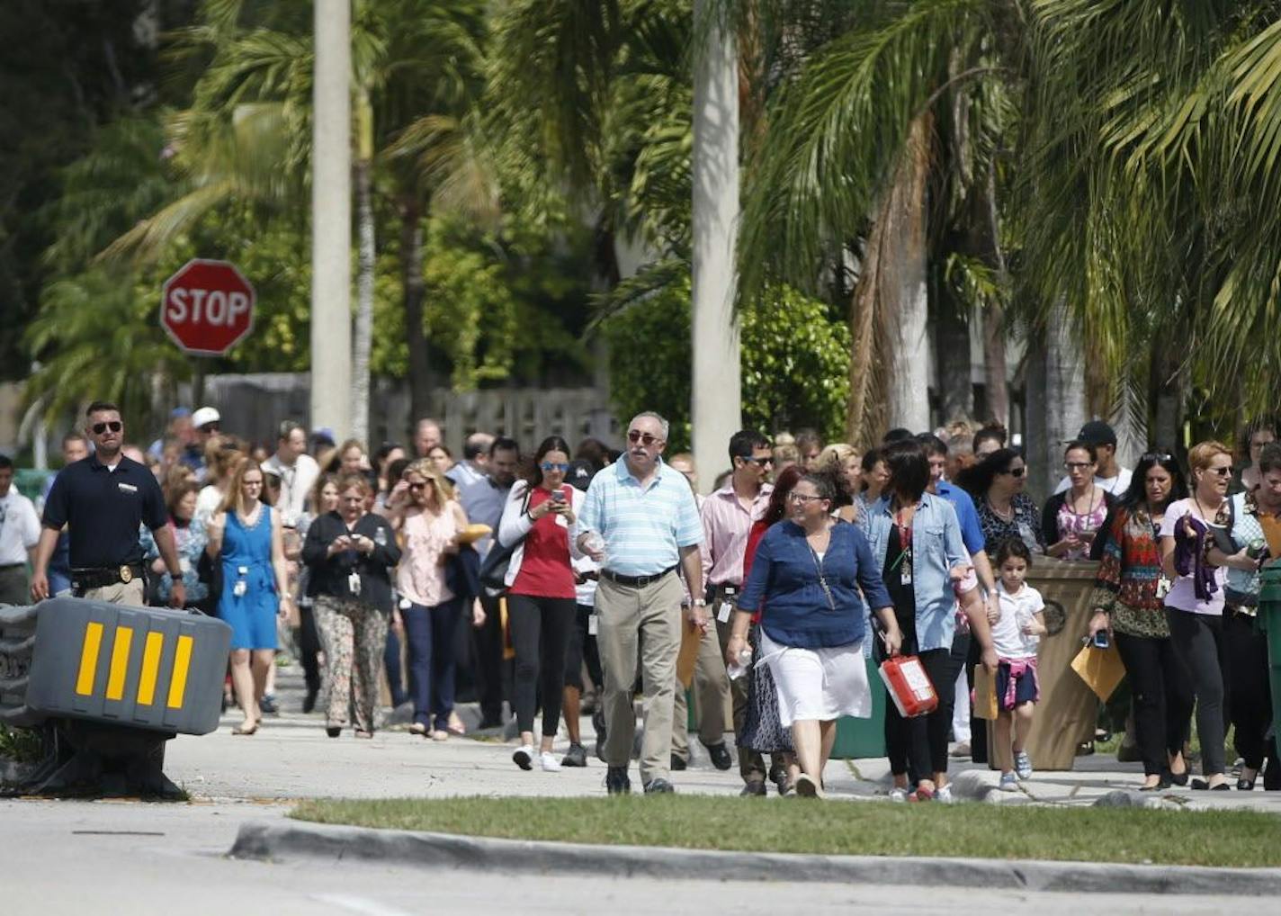 People evacuated because of a bomb threat return to the David Posnack Jewish Community Center and David Posnack Jewish Day School, Monday, Feb. 27, 2017, in Davie, Fla. Jewish centers and schools across the nation are coping with another wave of bomb threats as officials in Philadelphia begin raising money to repair and restore hundreds of vandalized headstones at a Jewish cemetery.