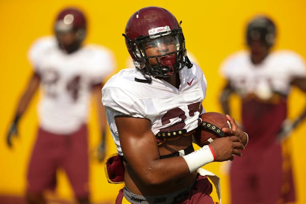 Senior running back David Cobb, who was the Gophers' first 1,200-yard rusher in eight years in 2013, carried the ball during drills Monday night.