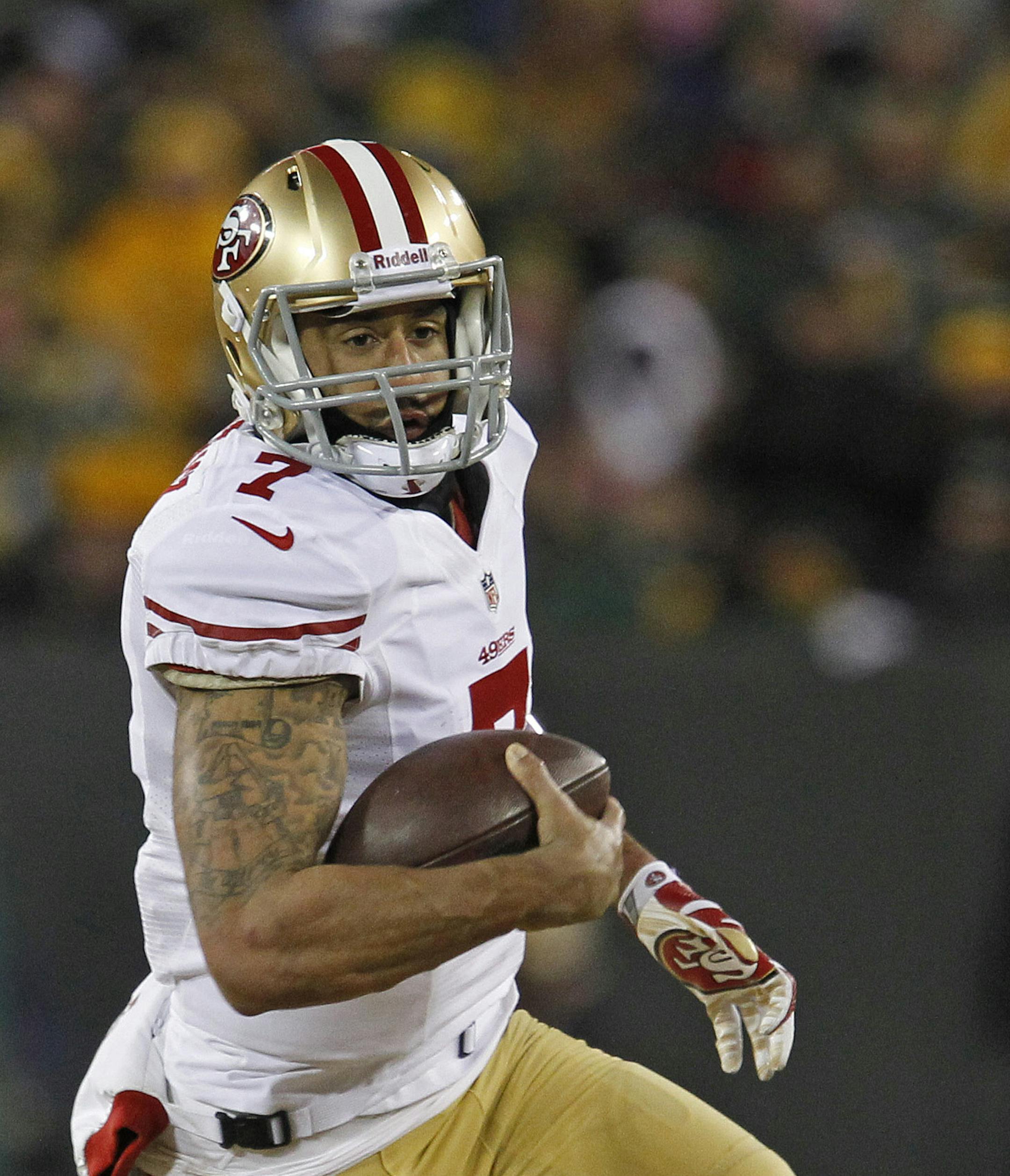San Francisco 49ers quarterback Colin Kaepernick rushes against the Green Bay Packers during an NFL wild-card playoff football game Sunday, Jan. 5, 2014, in Green Bay, Wis. (AP Photo/Matt Ludtke)